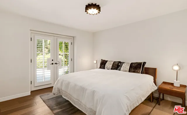 a bedroom with a large bed and a large window