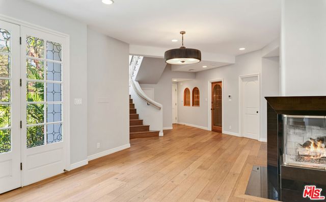 a view of swimming pool with a table and chairs under an umbrella