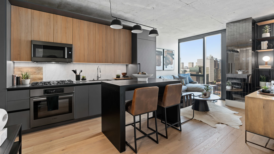 234 West Polk Street, Unit 3106 Chicago, IL 60607 - Photo 3 of 17 a kitchen with stainless steel appliances granite countertop a stove top oven a sink dishwasher a dining table and chairs with wooden floor