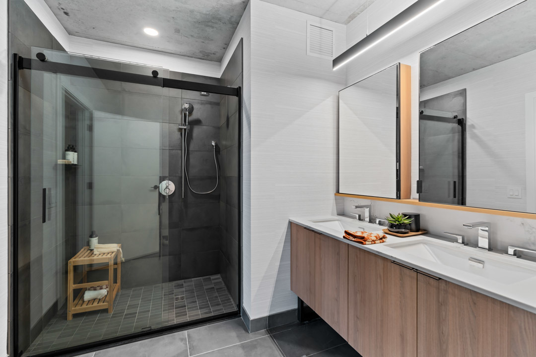 234 West Polk Street, Unit 3106 Chicago, IL 60607 - Photo 5 of 17 a bathroom with a granite countertop sink mirror and shower