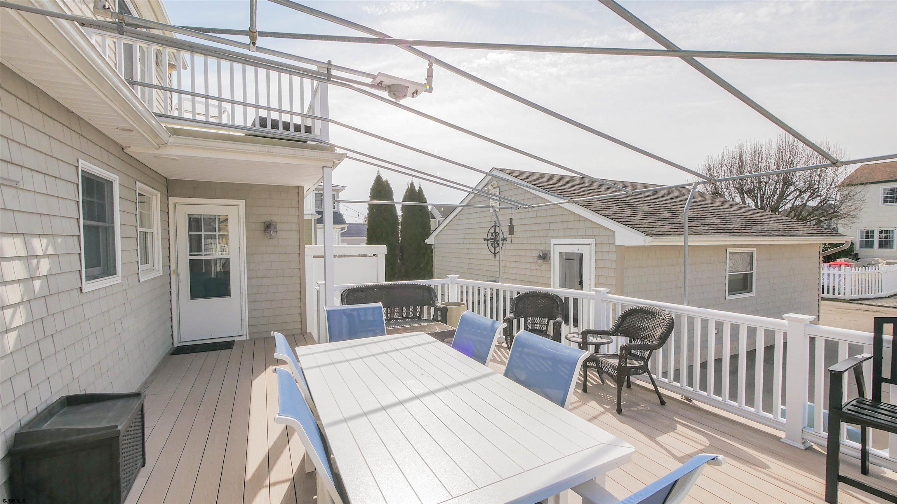 16 Spruce Road Ocean City, NJ 08226 - Photo 32 of 41 a balcony view with a dining table and chairs