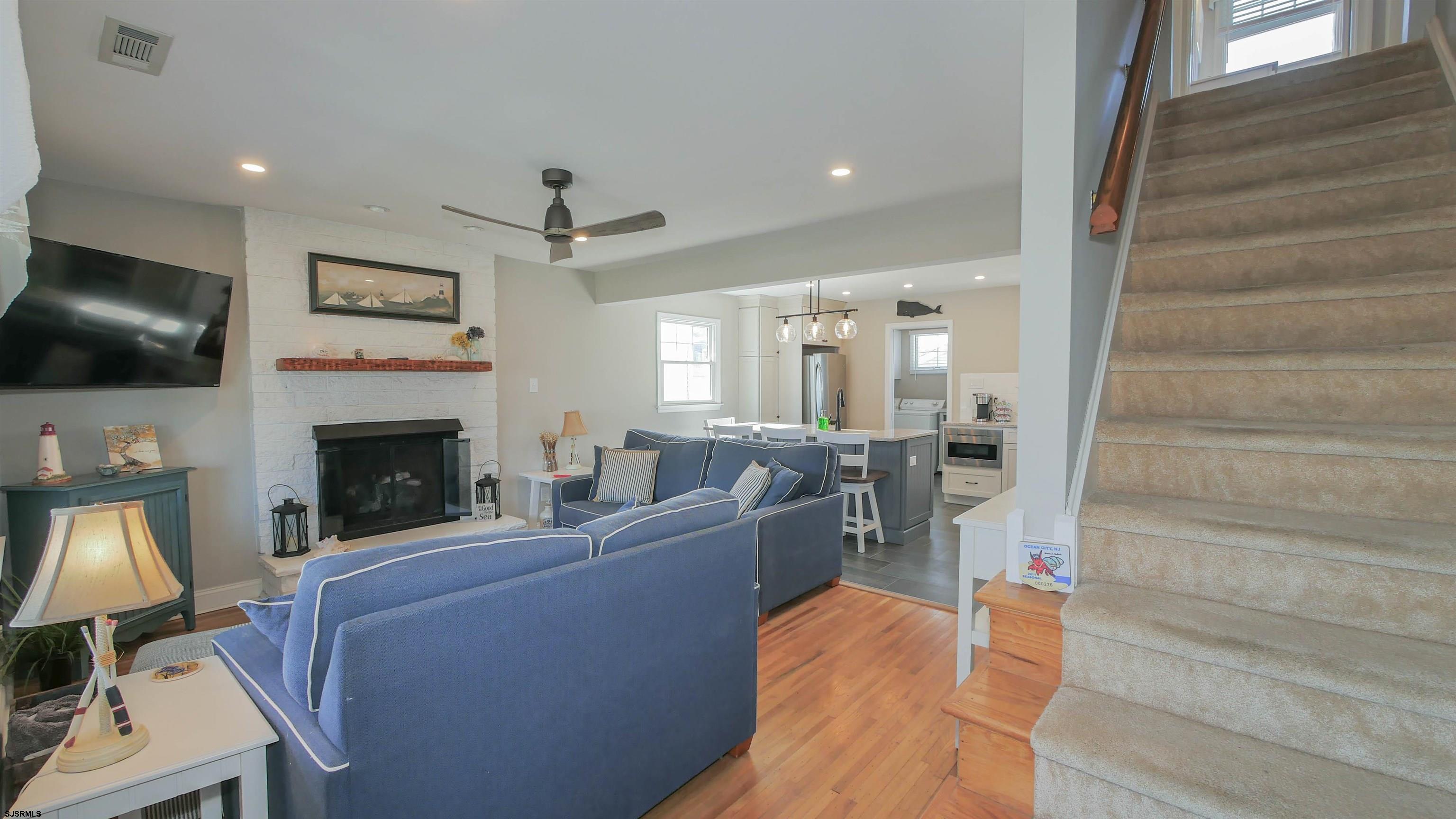 16 Spruce Road Ocean City, NJ 08226 - Photo 5 of 41 a living room with furniture a flat screen tv and a fireplace