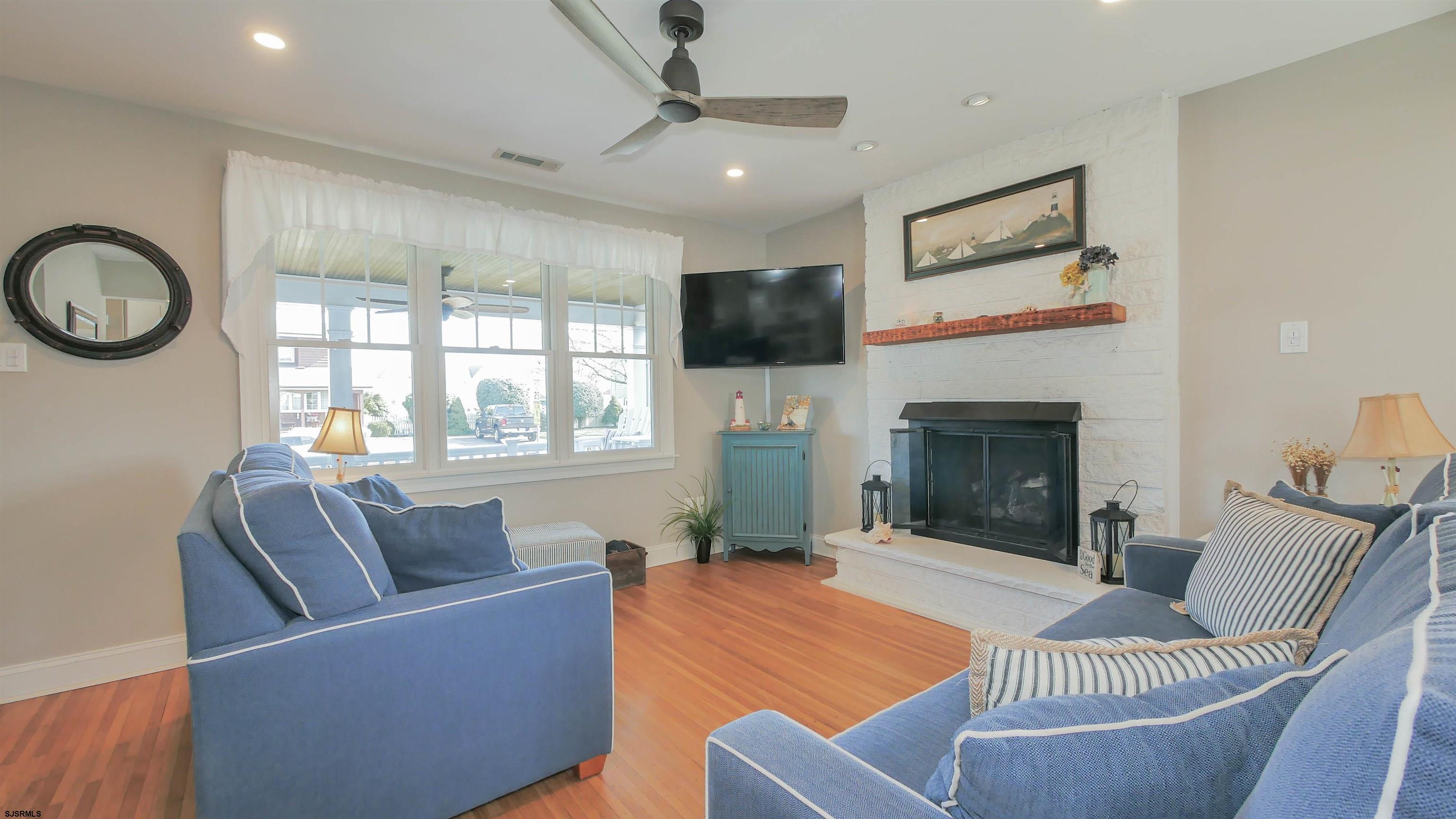 16 Spruce Road Ocean City, NJ 08226 - Photo 6 of 41 a living room with furniture a flat screen tv and a fireplace