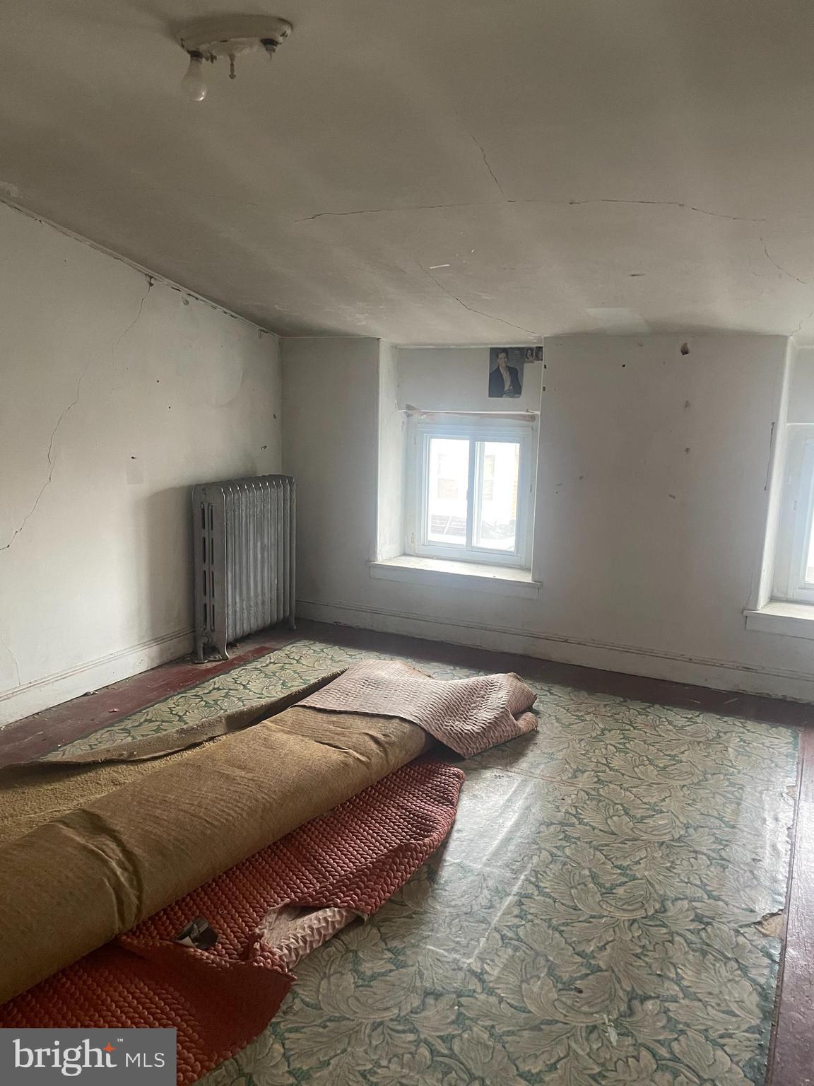 449 Delmar Street Philadelphia, PA 19128 - Photo 9 of 13 a bedroom with a bed and window