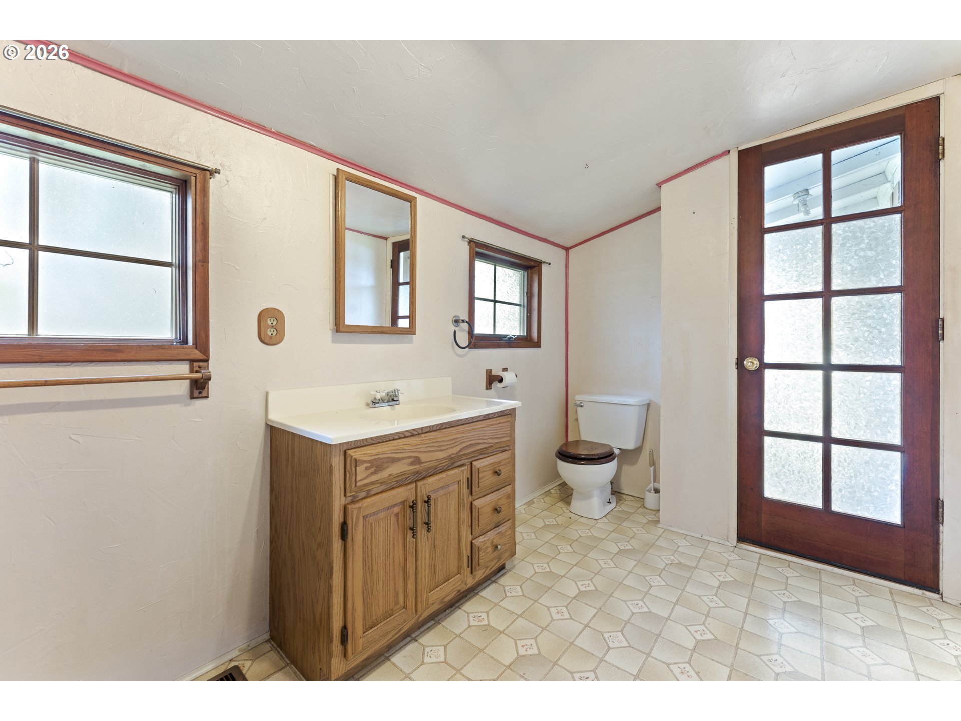 642 Clark Street North Bend, OR 97459 - Photo 19 of 29 a bathroom with a sink vanity mirror and toilet