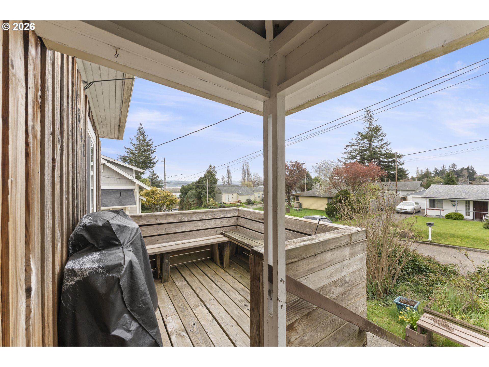 642 Clark Street North Bend, OR 97459 - Photo 3 of 29 a view of a balcony with floor to ceiling windows with wooden floor