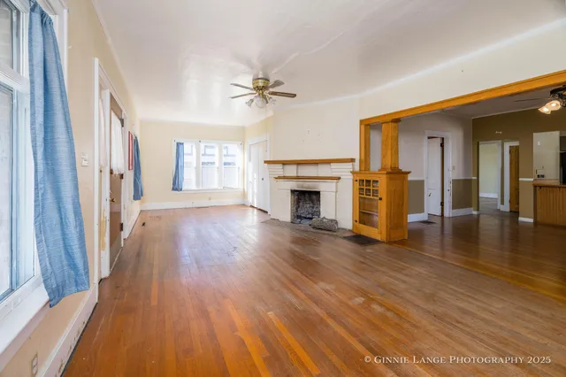 wooden floor in an empty room with a fireplace