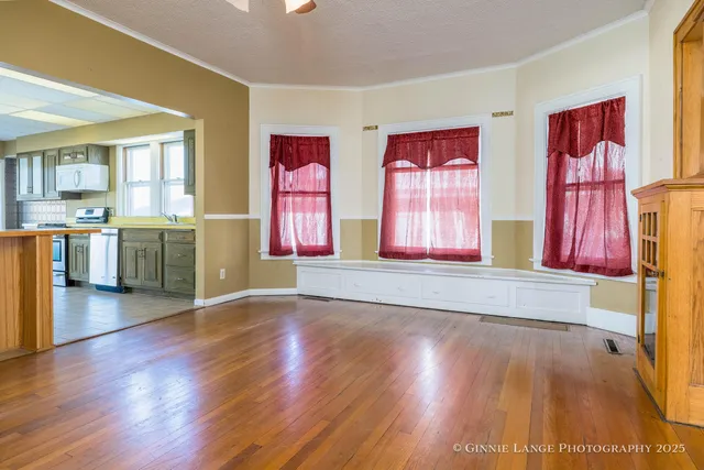 a view of front door with wooden floor and a window