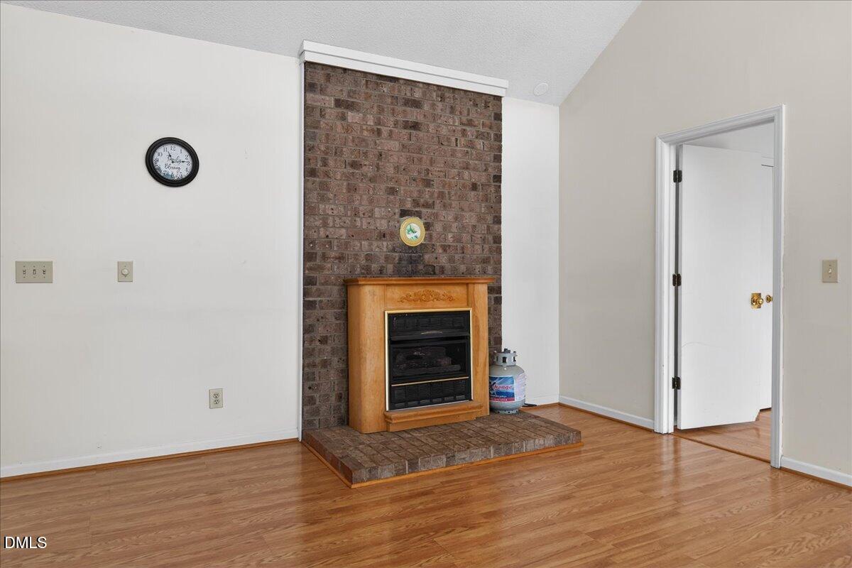 180 Manor Drive Timberlake, NC 27583 - Photo 13 of 85 a view of an empty room with wooden floor and a window