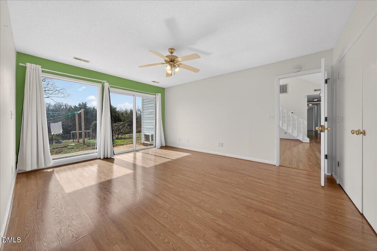 180 Manor Drive Timberlake, NC 27583 - Photo 15 of 85 a view of an empty room with a window and wooden floor