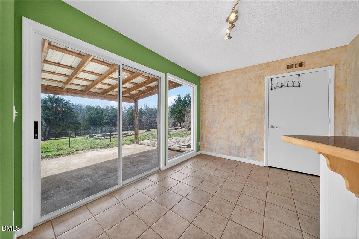 180 Manor Drive Timberlake, NC 27583 - Photo 23 of 85 a view of an empty room with window view and front door