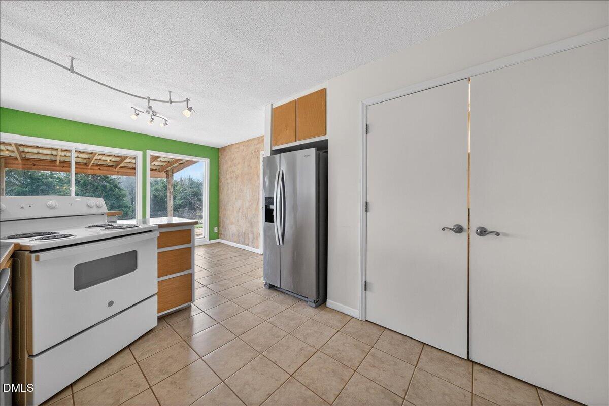 180 Manor Drive Timberlake, NC 27583 - Photo 29 of 85 a kitchen with stainless steel appliances granite countertop a refrigerator and a sink