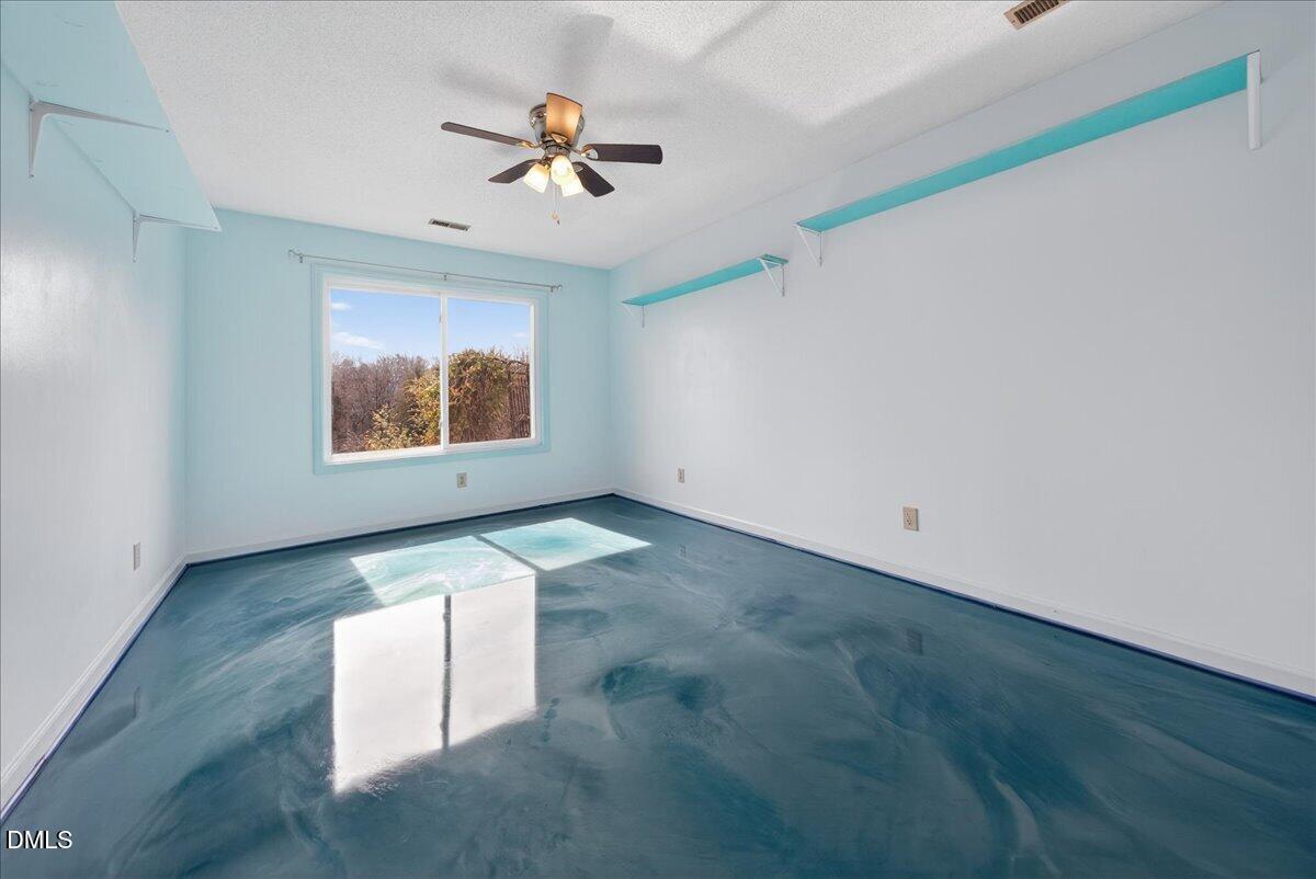 180 Manor Drive Timberlake, NC 27583 - Photo 32 of 85 a view of empty room with wooden floor and fan
