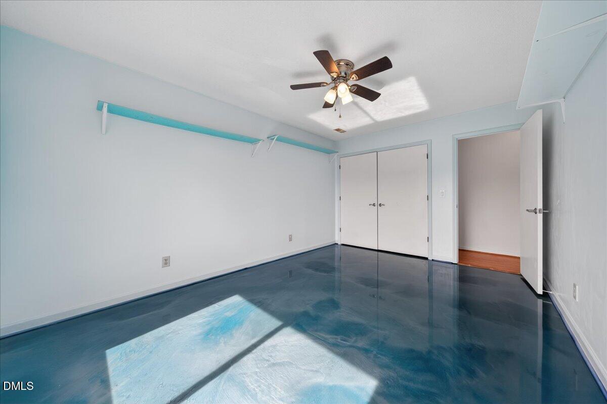 180 Manor Drive Timberlake, NC 27583 - Photo 33 of 85 an empty room with wooden floor and fan