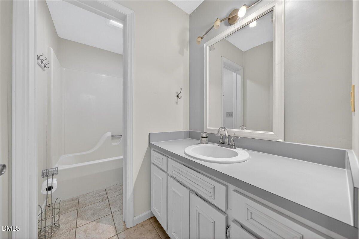 180 Manor Drive Timberlake, NC 27583 - Photo 35 of 85 a bathroom with a sink and a mirror