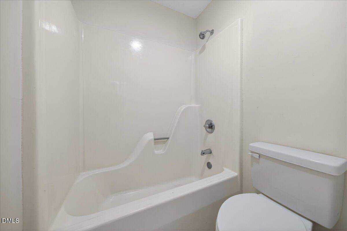180 Manor Drive Timberlake, NC 27583 - Photo 37 of 85 a bathroom with a toilet and bathtub