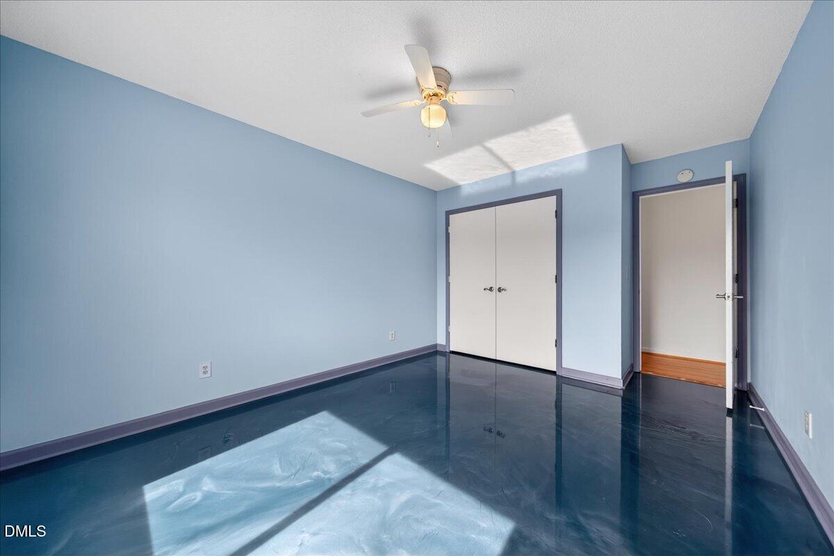 180 Manor Drive Timberlake, NC 27583 - Photo 39 of 85 an empty room with wooden floor and fan