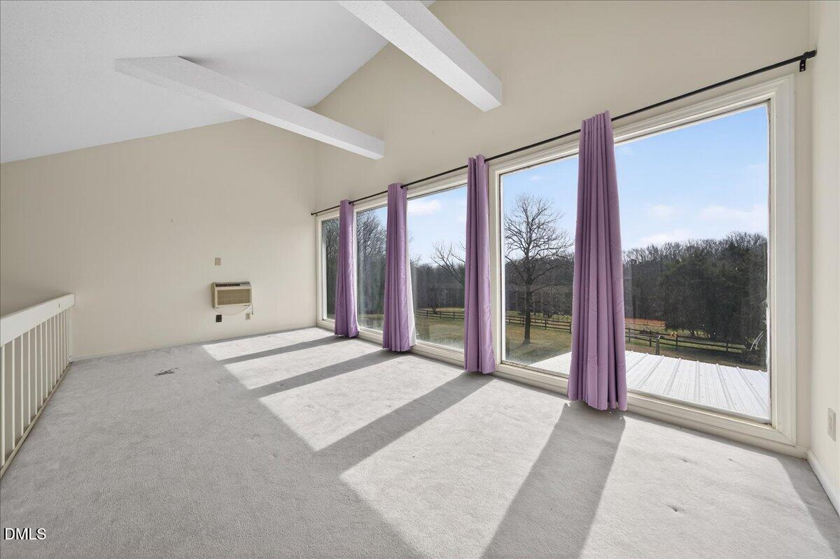 180 Manor Drive Timberlake, NC 27583 - Photo 43 of 85 a view of a big room with a balcony and a bed