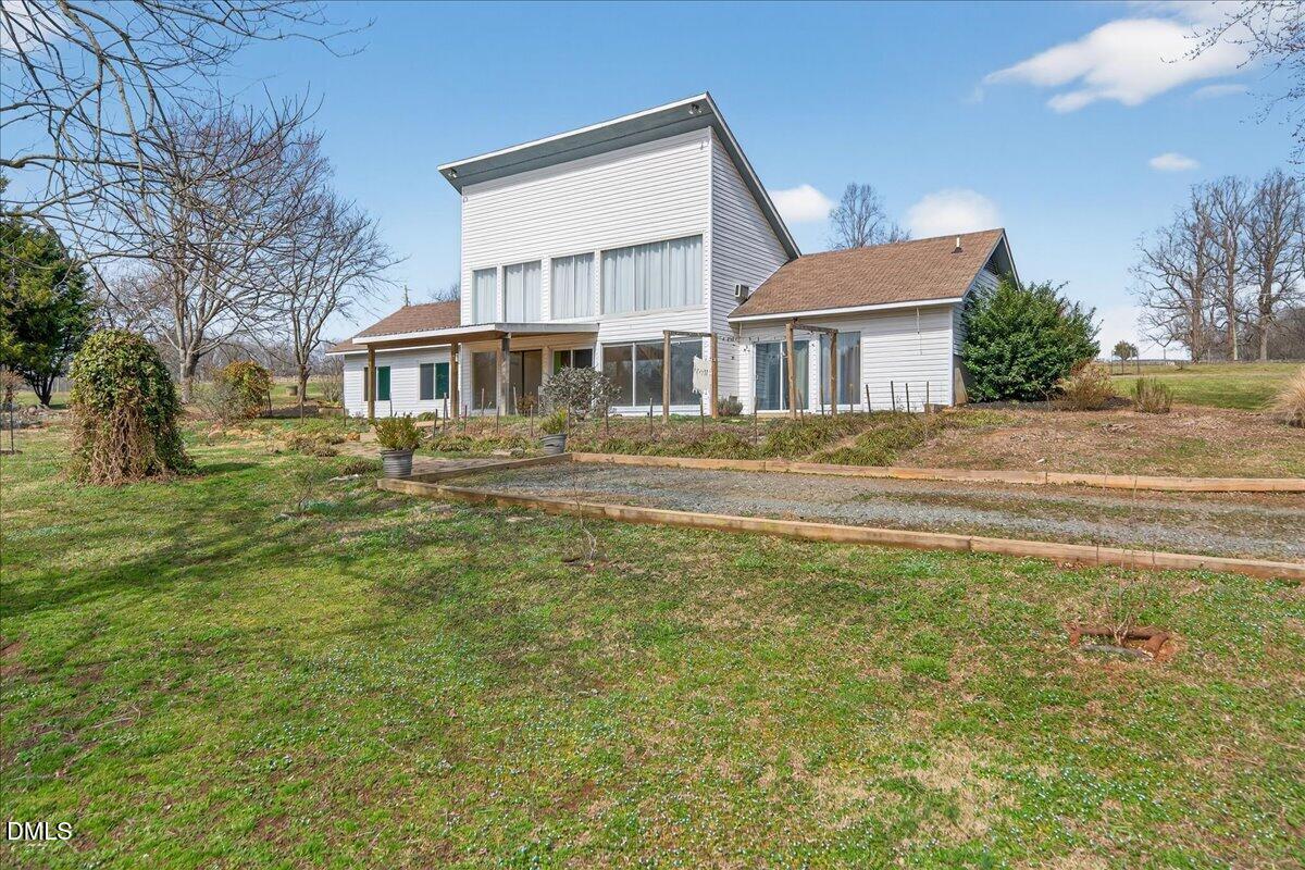 180 Manor Drive Timberlake, NC 27583 - Photo 52 of 85 a front view of a house with a garden