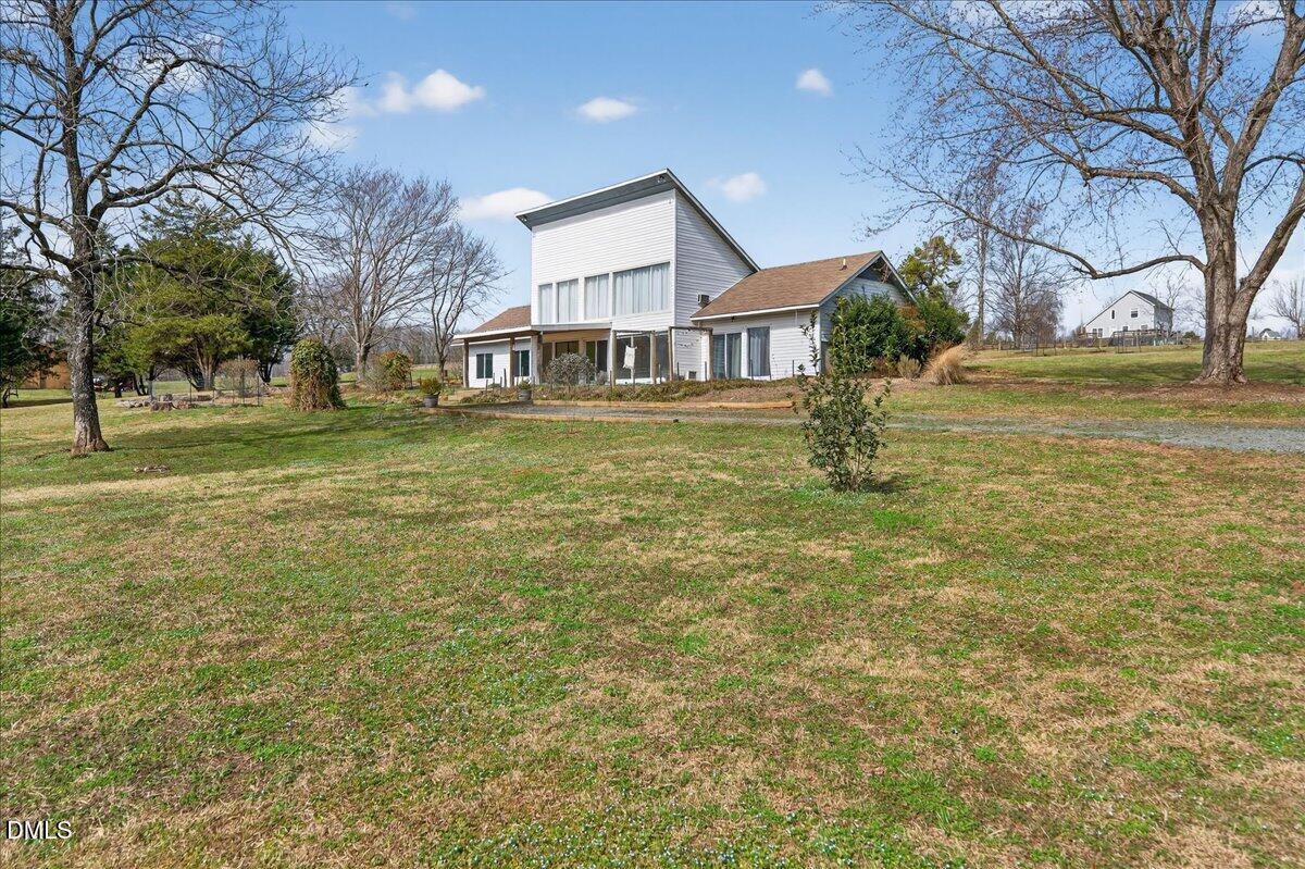 180 Manor Drive Timberlake, NC 27583 - Photo 55 of 85 a front view of a house with a garden and trees