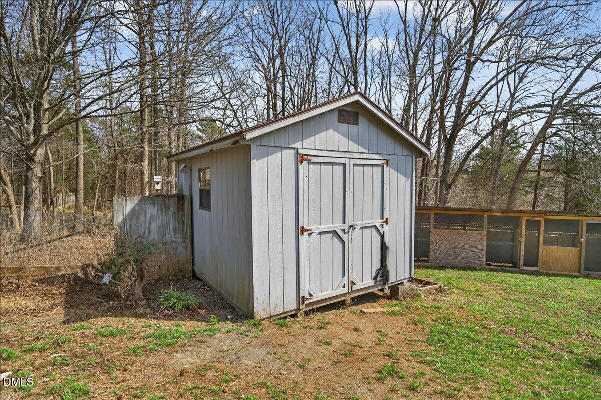 180 Manor Drive Timberlake, NC 27583 - Photo 65 of 85 a backyard of a house with large trees and wooden fence