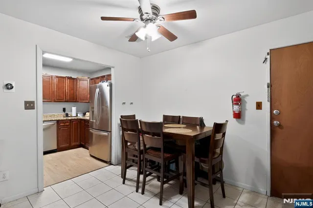 a view of a dining room with furniture and a chandelier