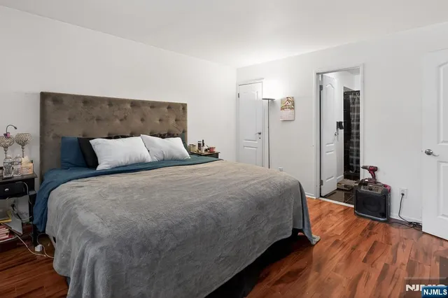 a bedroom with a bed and lamp