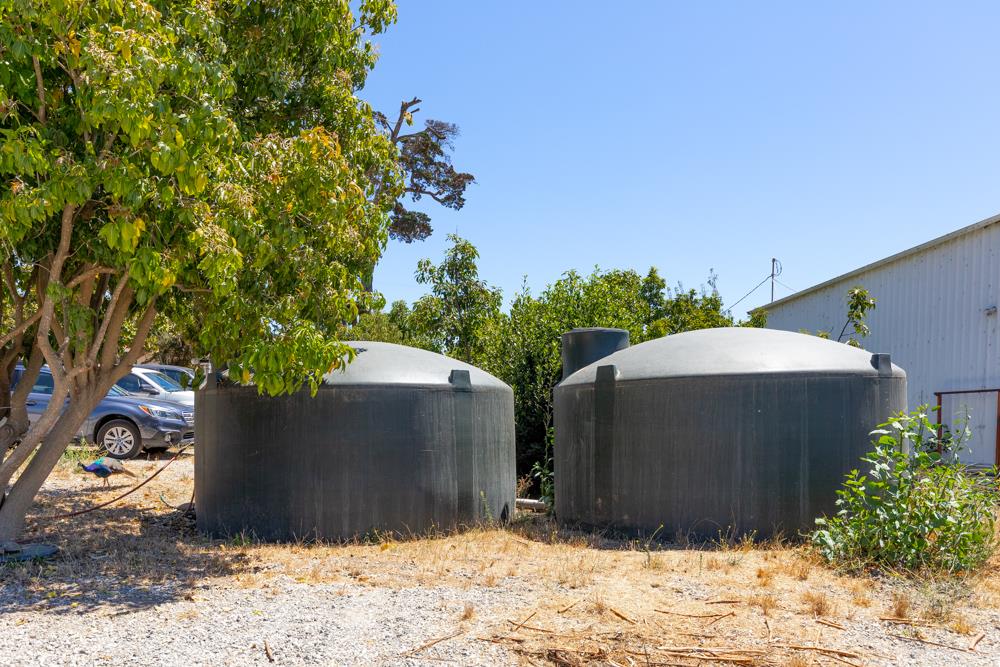 189 Hughes Road Watsonville, CA 95076 - Photo 21 of 35 a couple of table and chairs under an umbrella in backyard