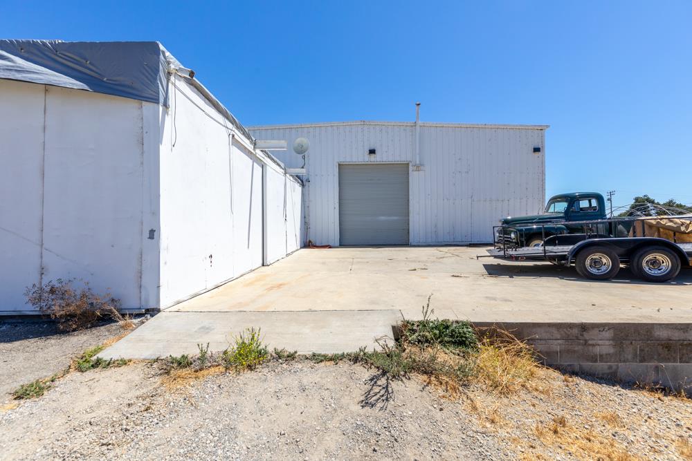 189 Hughes Road Watsonville, CA 95076 - Photo 10 of 35 a bedroom with a bed and a car parked in front of it