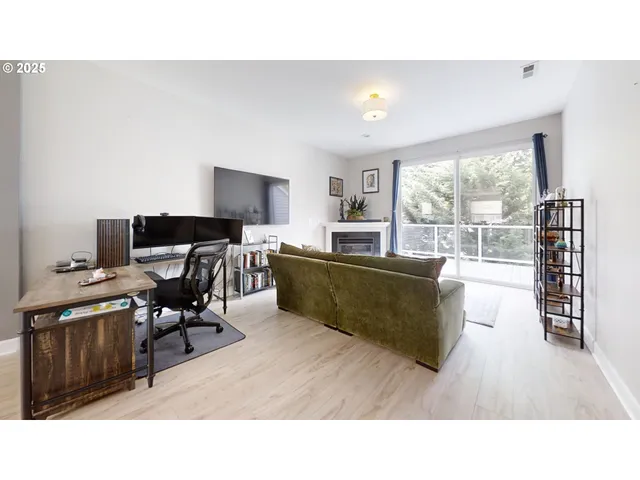 a living room with a fireplace and a floor to ceiling window