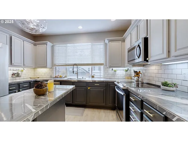 a kitchen with a sink and large window
