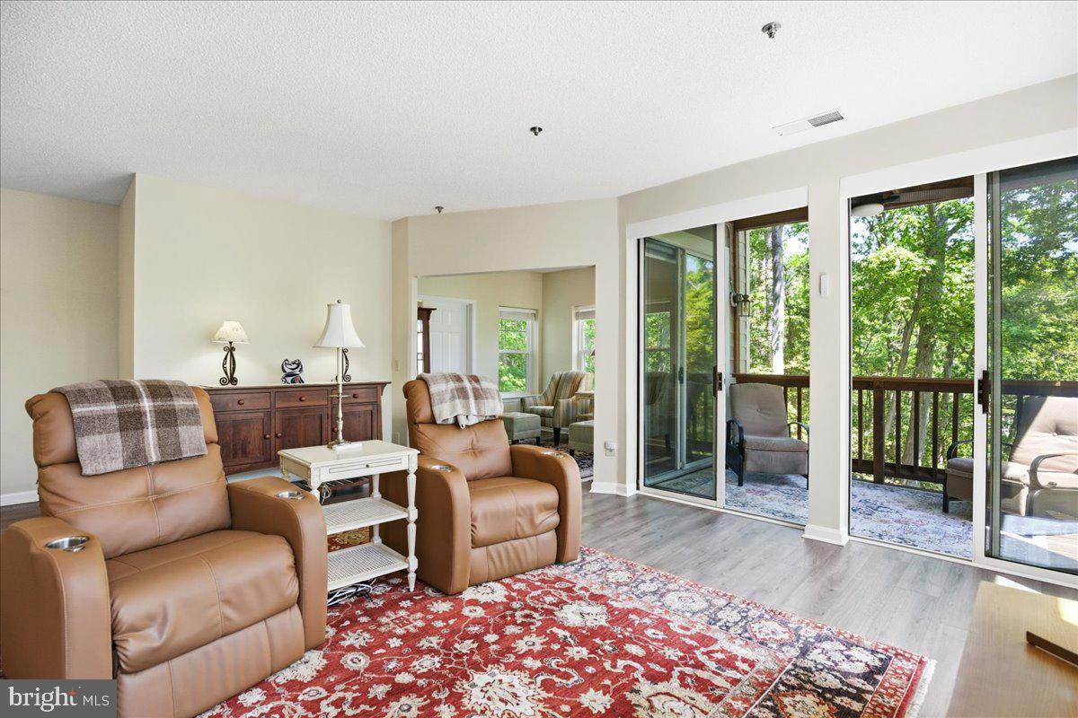 1126 Back Creek Loop, Unit 1126 Solomons, MD 20688 - Photo 20 of 47 a living room with furniture and a large window