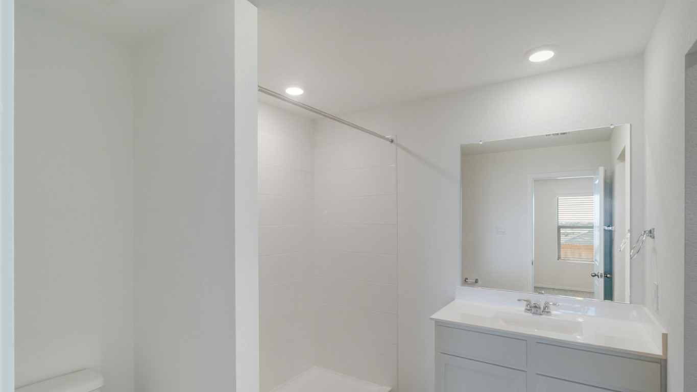 345 Bull Lake Circle Buda, TX 78610 - Photo 12 of 17 a bathroom with a sink and a mirror