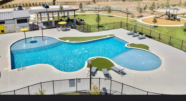 a view of a swimming pool with lounge chairs