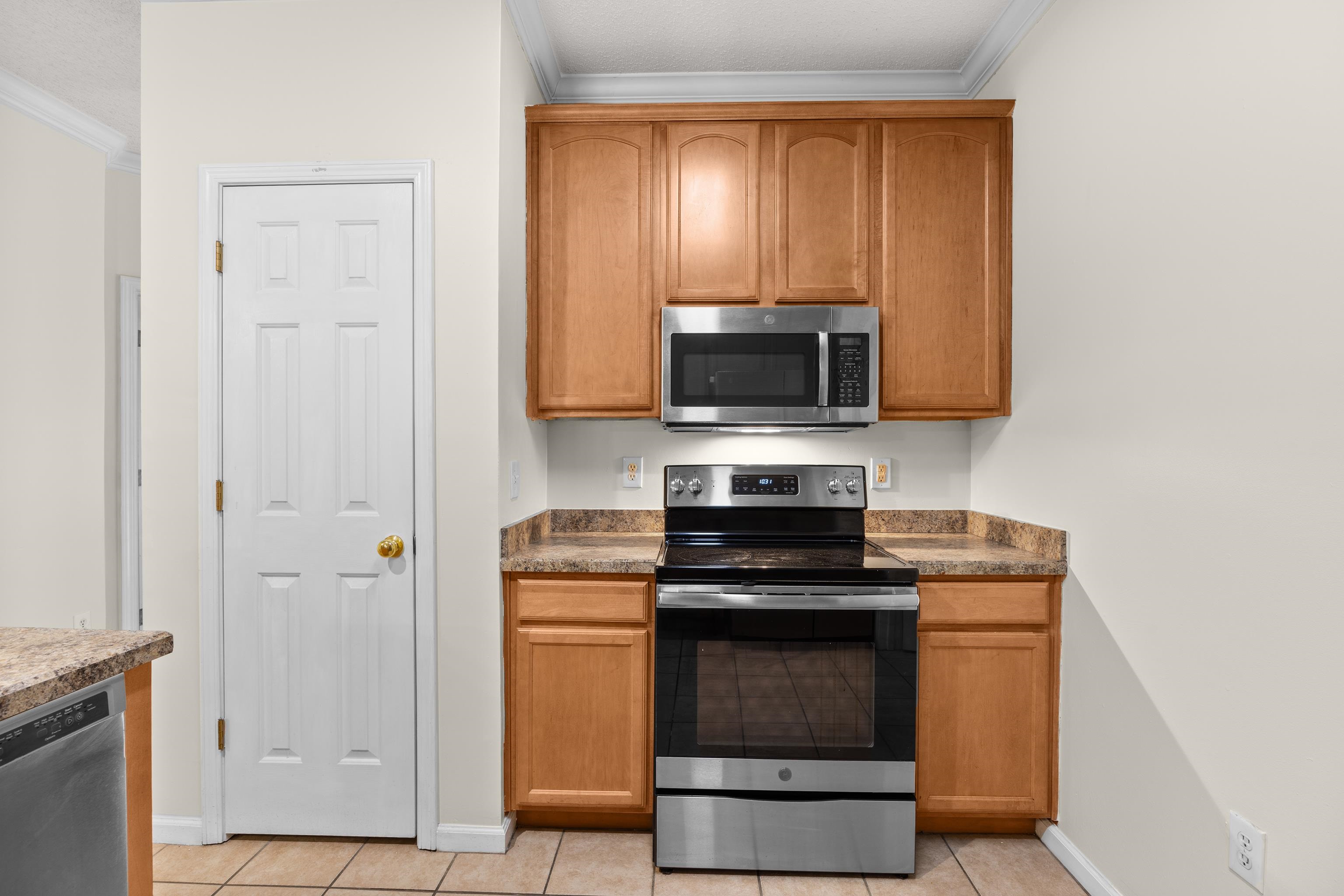 5846 Longwood Drive, Unit 203 Murrells Inlet, SC 29576 - Photo 11 of 38 Stainless steel appliances, pantry, and tile flooring.
