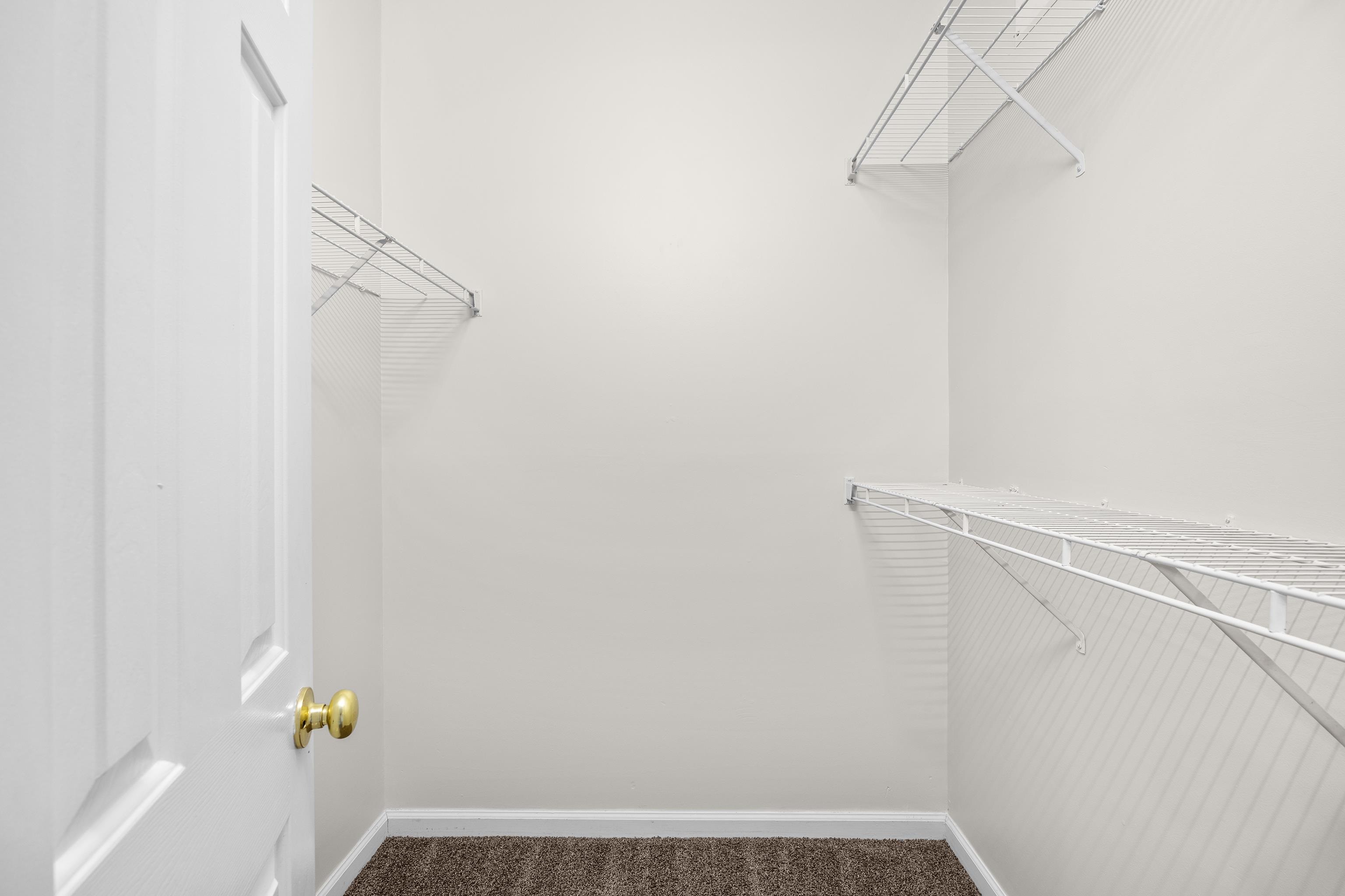5846 Longwood Drive, Unit 203 Murrells Inlet, SC 29576 - Photo 17 of 38 The walk-in closet in the primary bedroom features vented wire shelving.