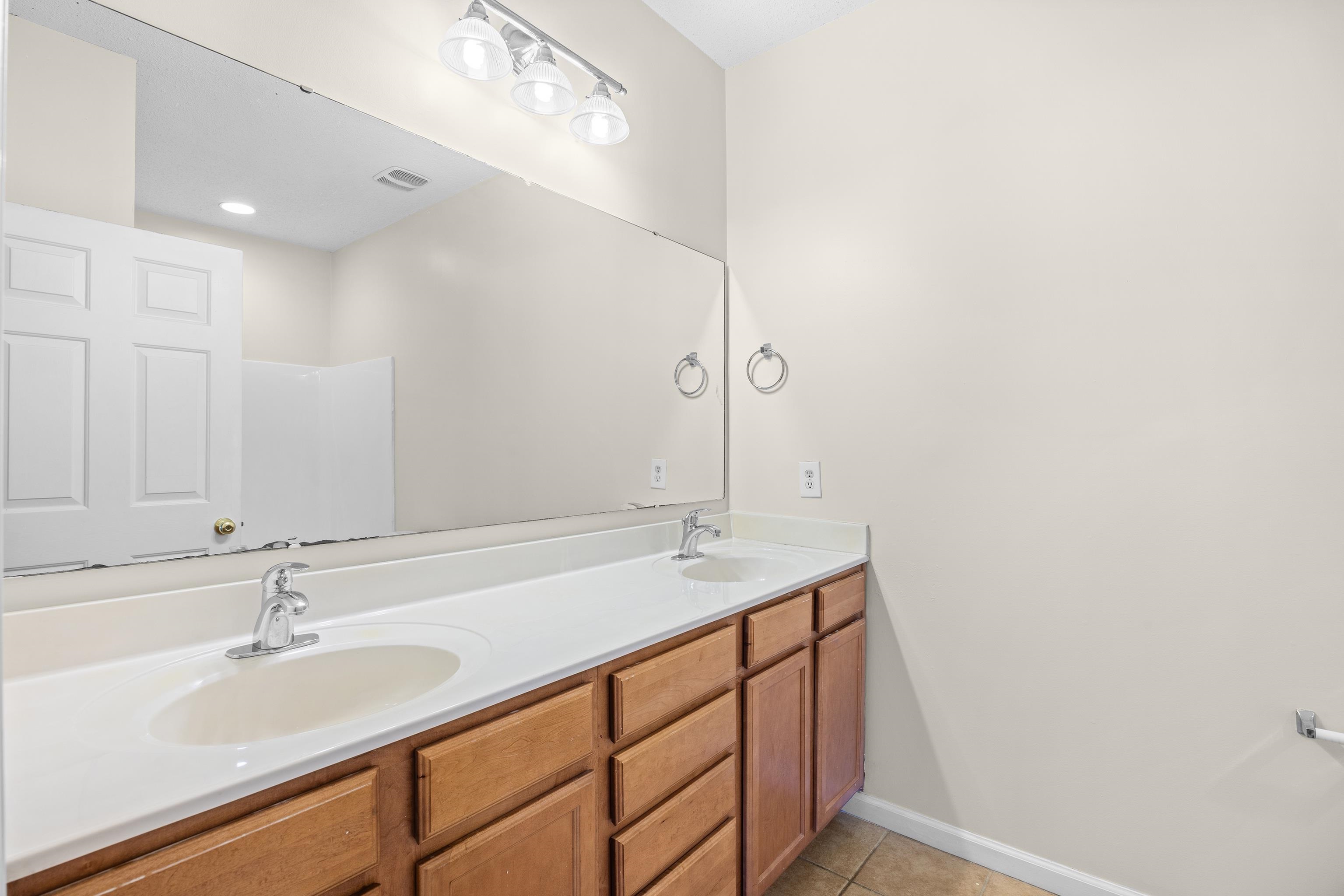 5846 Longwood Drive, Unit 203 Murrells Inlet, SC 29576 - Photo 18 of 38 Double sinks and vanity, toilet, and a shower and tub combination. The main bathroom area is spacious.