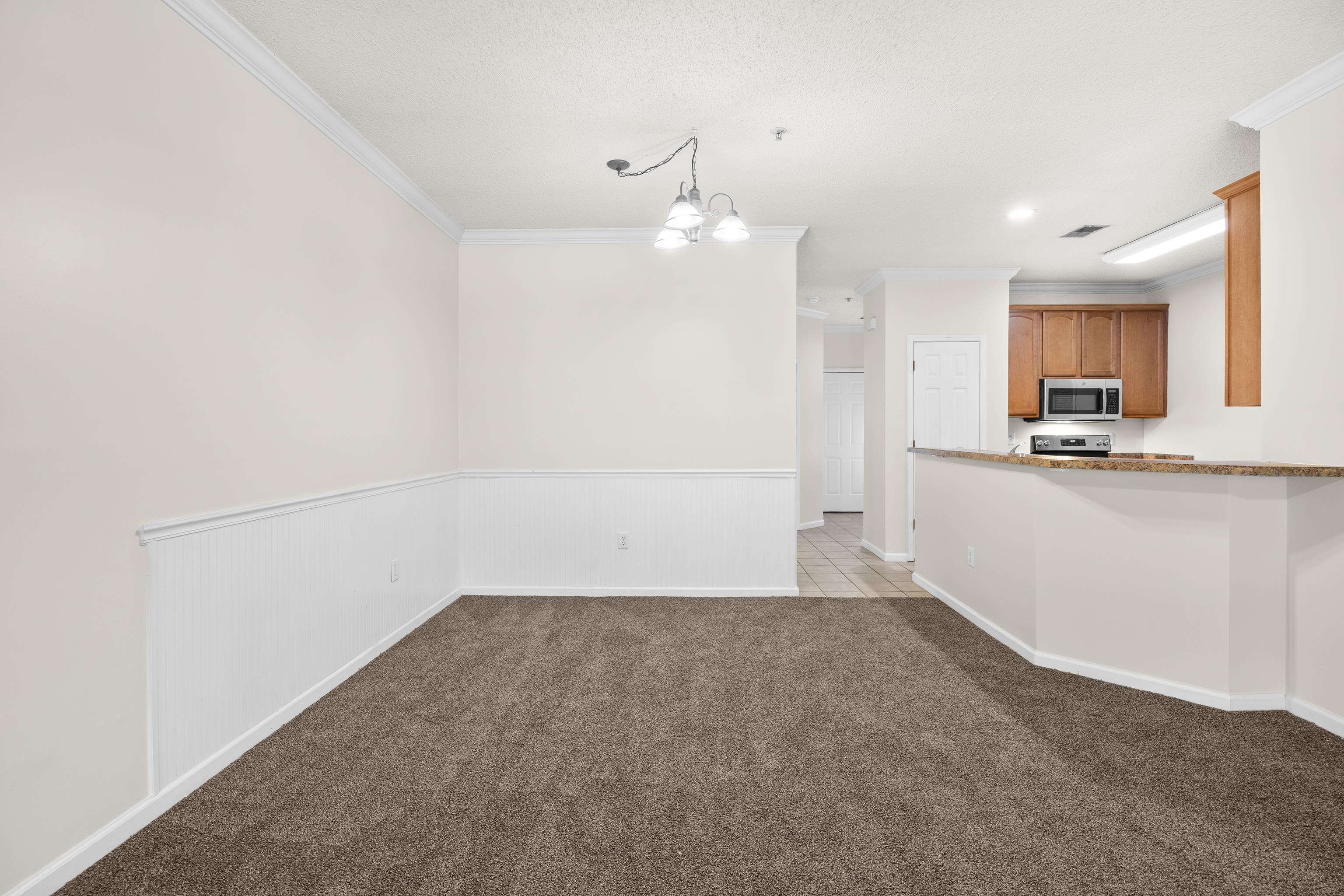 5846 Longwood Drive, Unit 203 Murrells Inlet, SC 29576 - Photo 22 of 38 New carpet, and walls have been painted. The dining area is open to the living room and close to the kitchen.