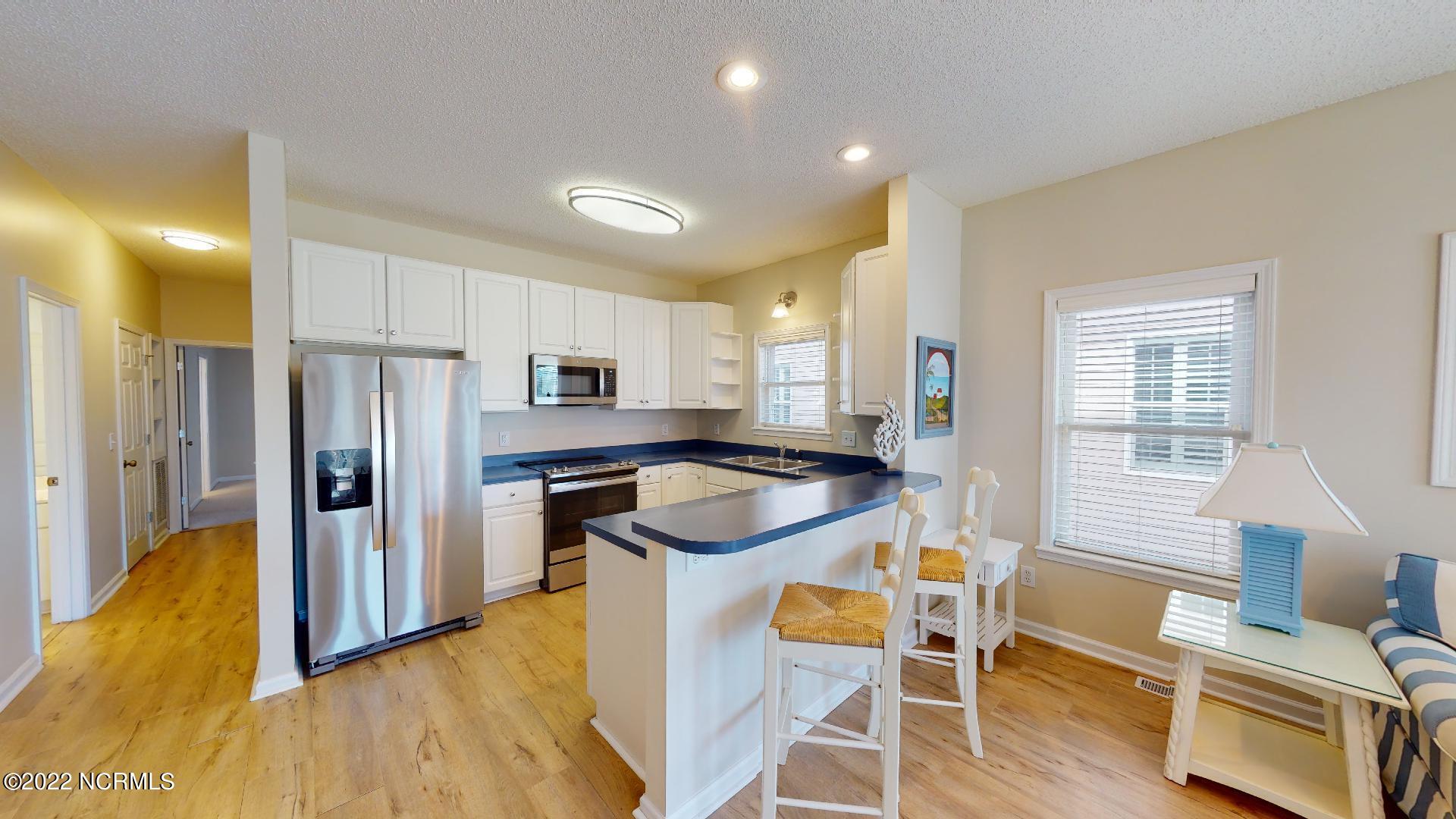 409 27th Street, Unit A Sunset Beach, NC 28468 - Photo 9 of 37 Kitchen Breakfast Bar