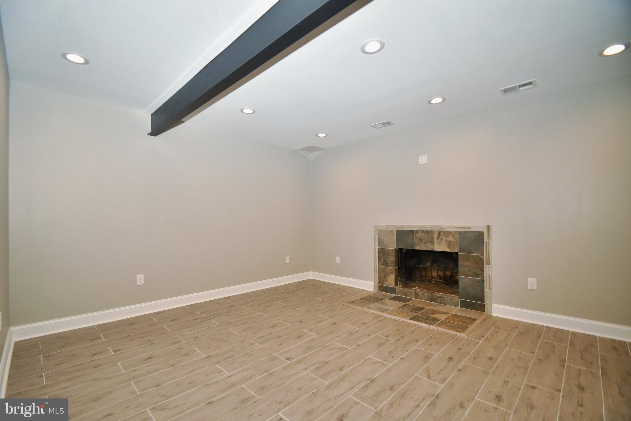 4817 Variation Road Baltimore, MD 21236 - Photo 32 of 42 Newly finished basement with fireplace!