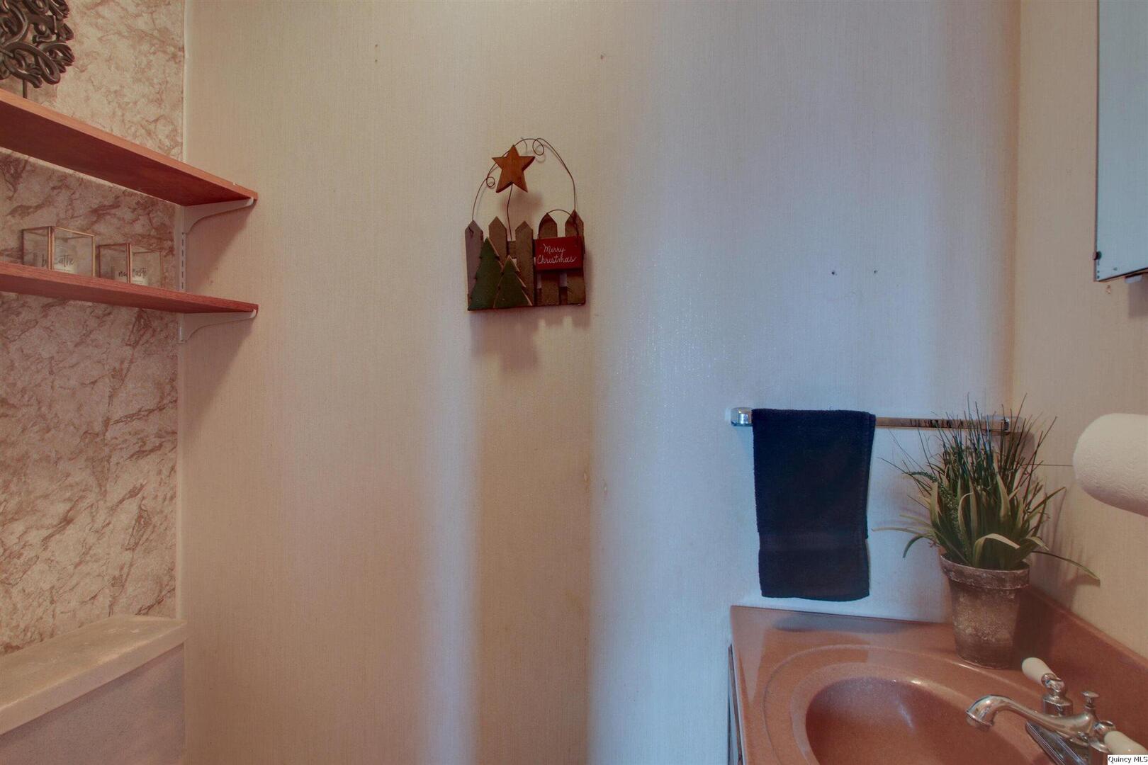 523 Temple Street Quincy, IL 62305 - Photo 12 of 23 a bathroom with a toilet and a sink