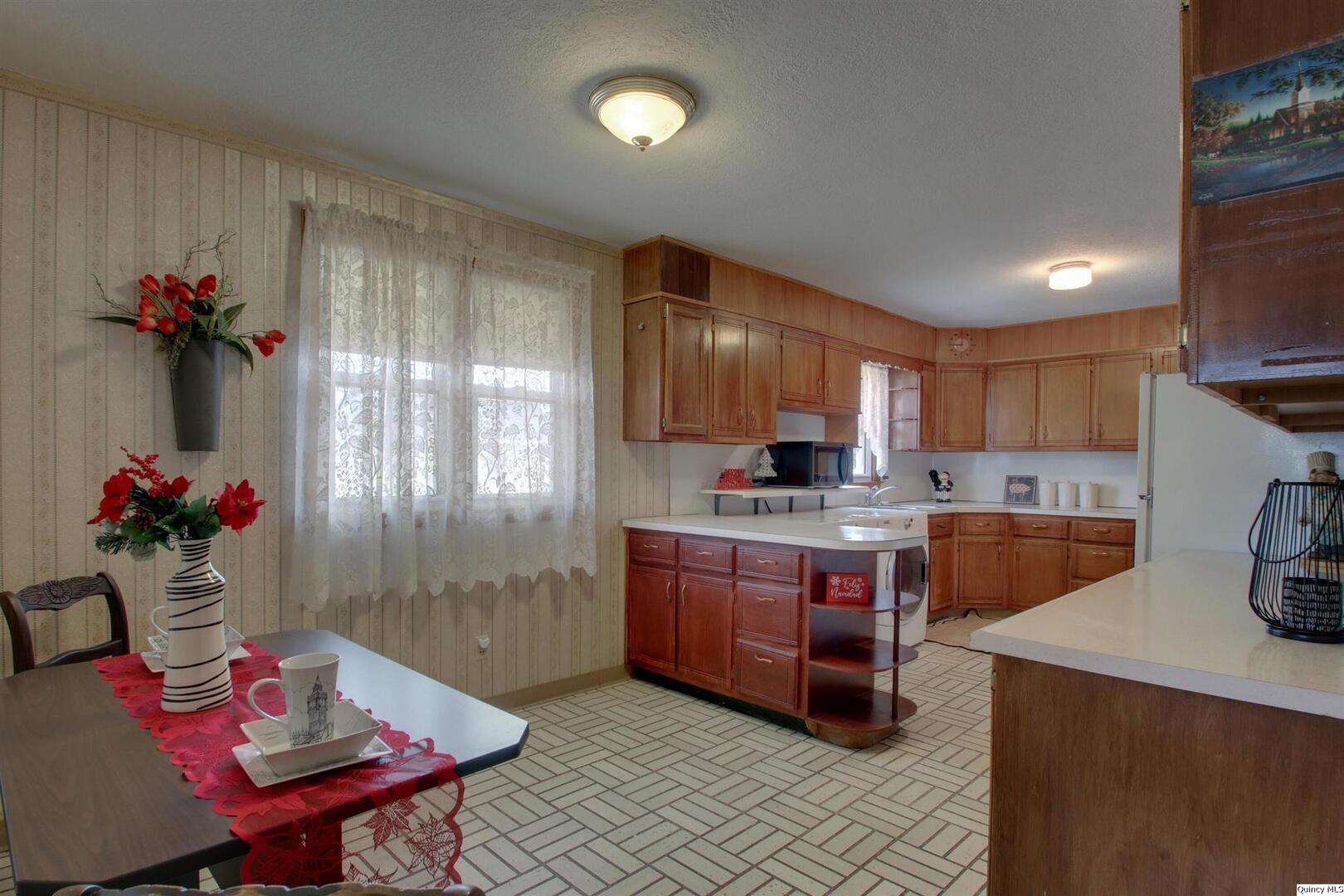 523 Temple Street Quincy, IL 62305 - Photo 14 of 23 a kitchen with sink a refrigerator and cabinets