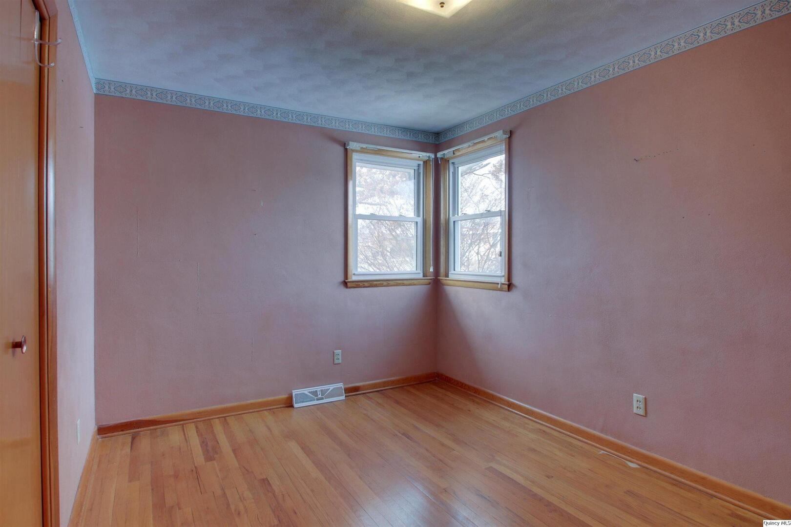 523 Temple Street Quincy, IL 62305 - Photo 16 of 23 a view of an empty room with wooden floor and a window
