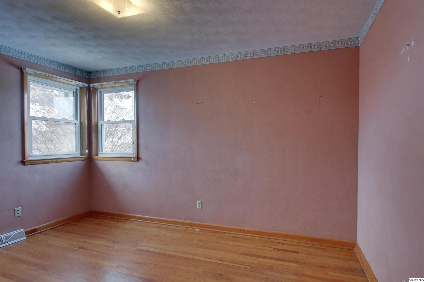 523 Temple Street Quincy, IL 62305 - Photo 17 of 23 an empty room with wooden floor and windows