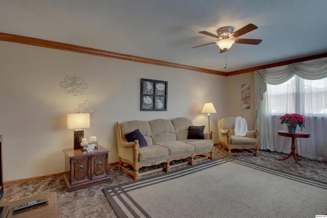 a living room with furniture and a lamp