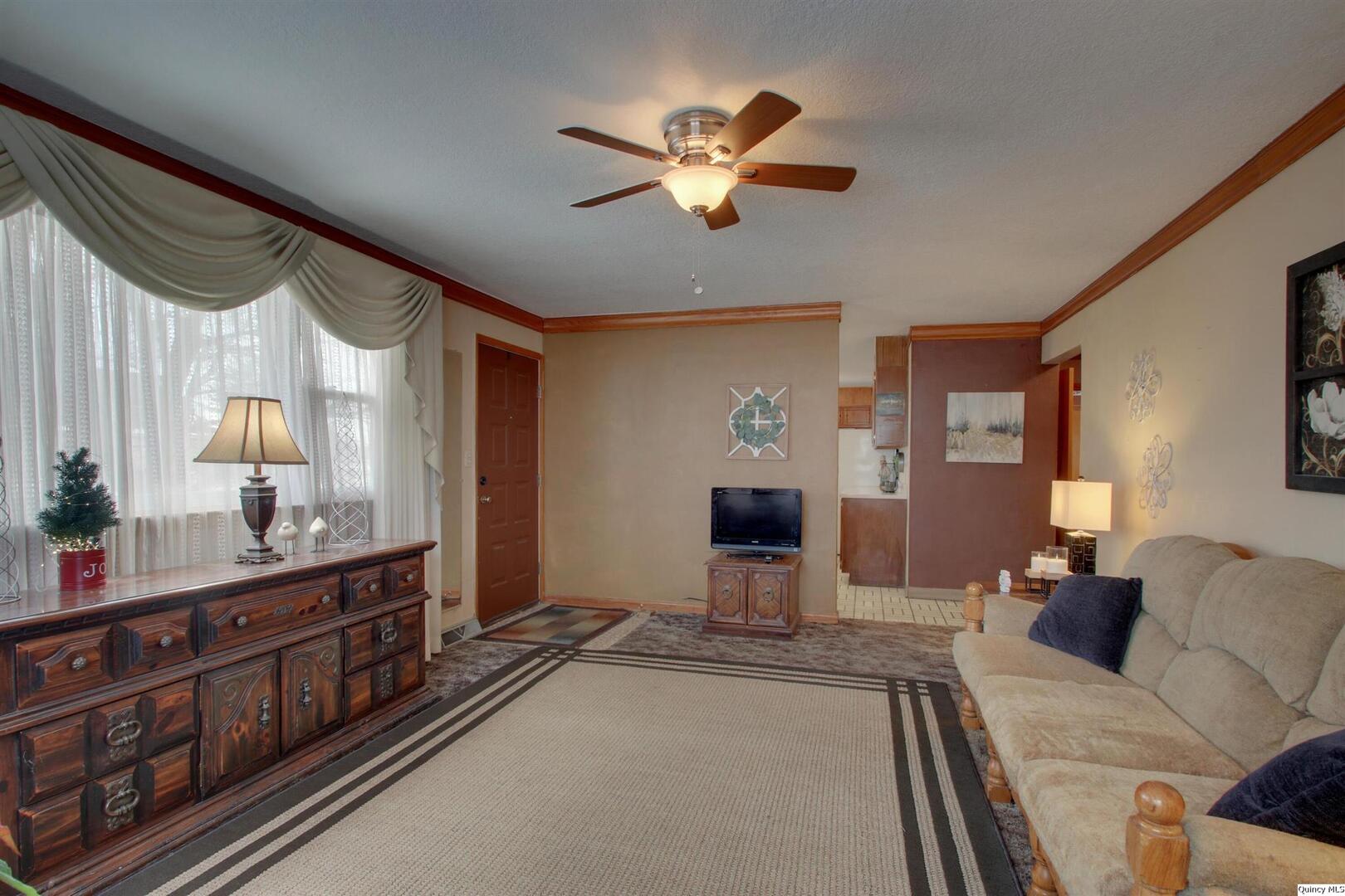 523 Temple Street Quincy, IL 62305 - Photo 7 of 23 a living room with furniture and a chandelier