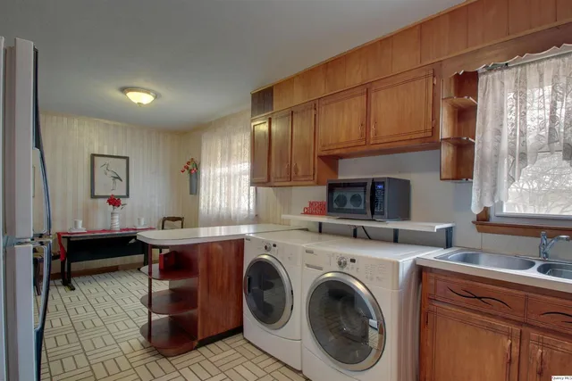 a kitchen with a sink a stove and cabinets