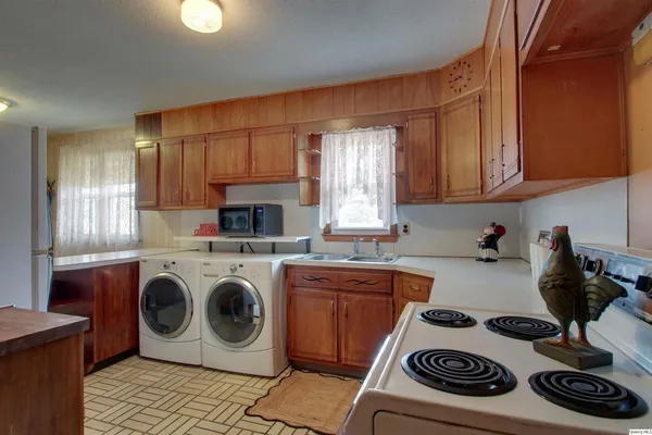 a kitchen with a stove and white cabinets