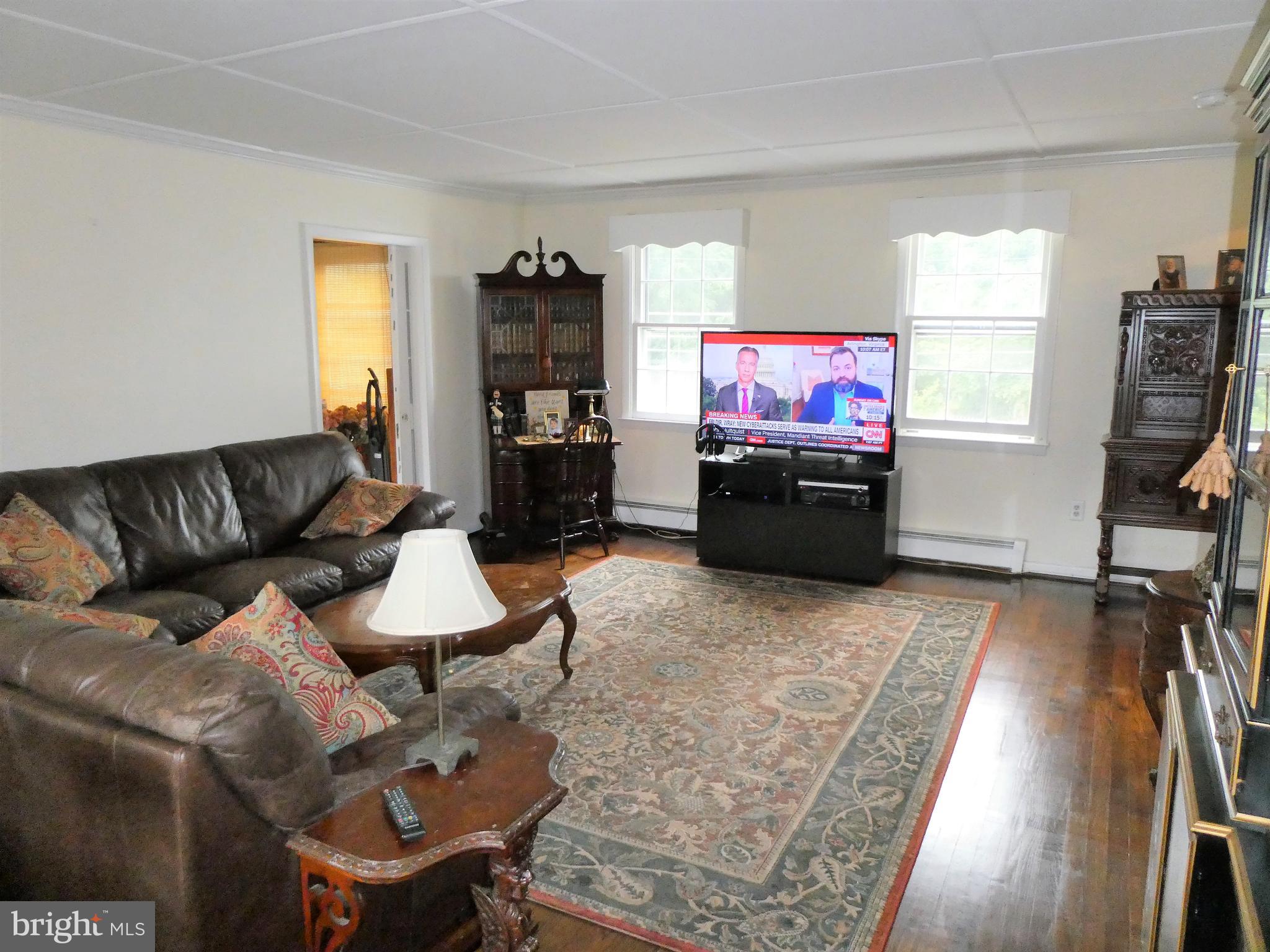 915 Stone Road Laurel Springs, NJ 08021 - Photo 3 of 30 a living room with furniture and a flat screen tv