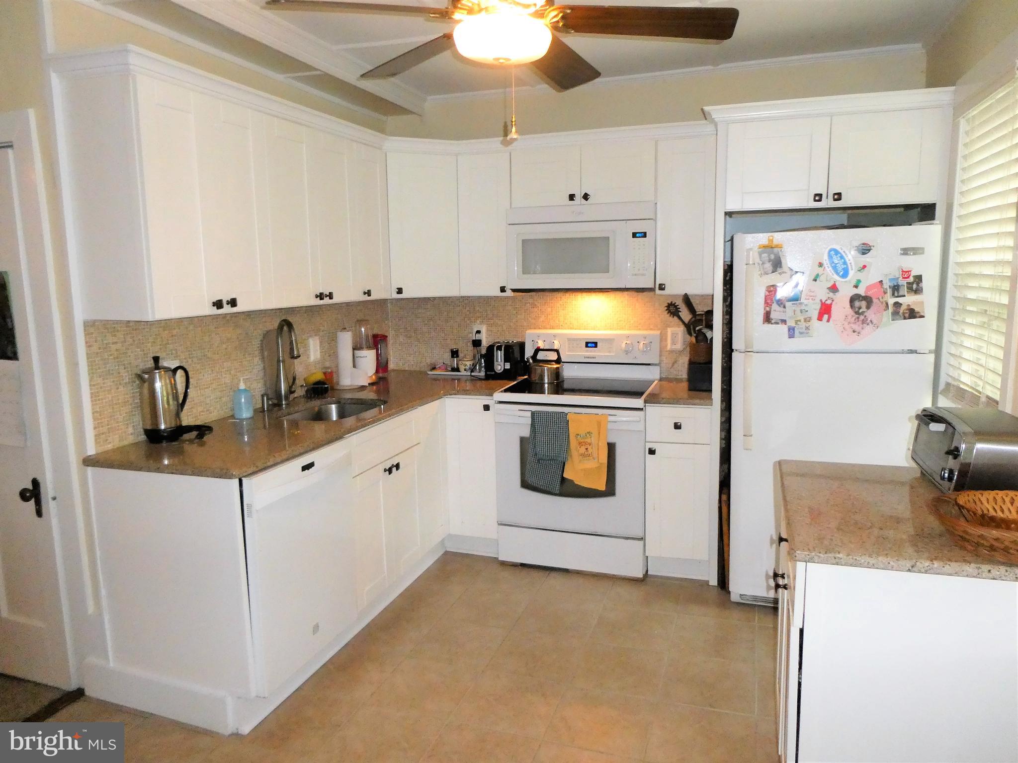 915 Stone Road Laurel Springs, NJ 08021 - Photo 5 of 30 a kitchen with granite countertop a sink a stove and cabinets